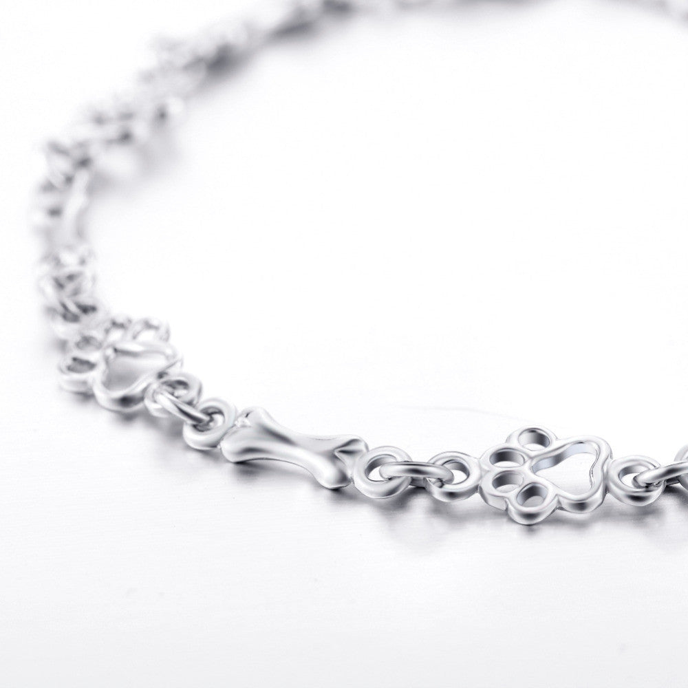 Silberarmband mit Pfotenabdruck und Knochenmotiv